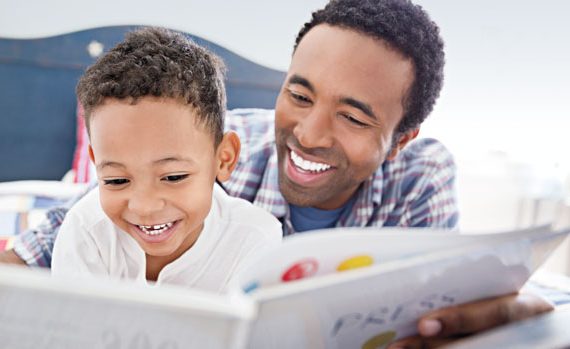 Father reading to his son.