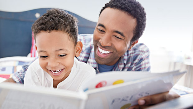 Father reading to his son.