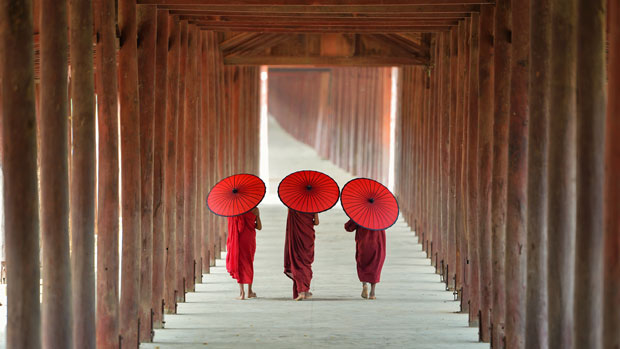 Buddhist monks walking down a corridor.