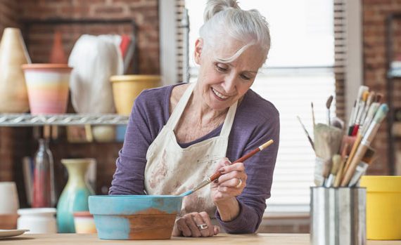 Woman painting pottery