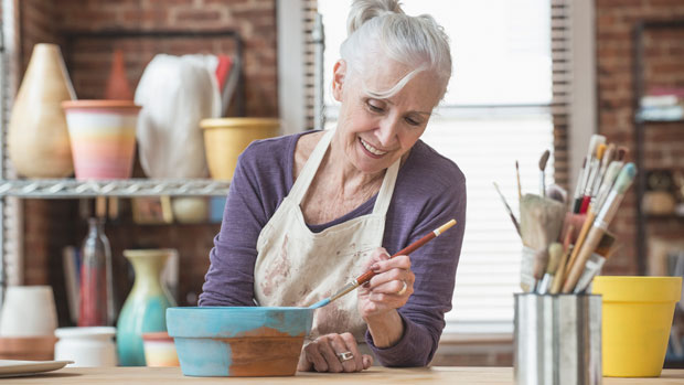 Woman painting pottery