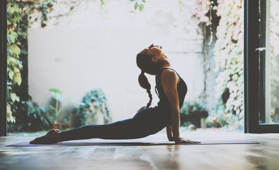 Woman doing yoga in her home.