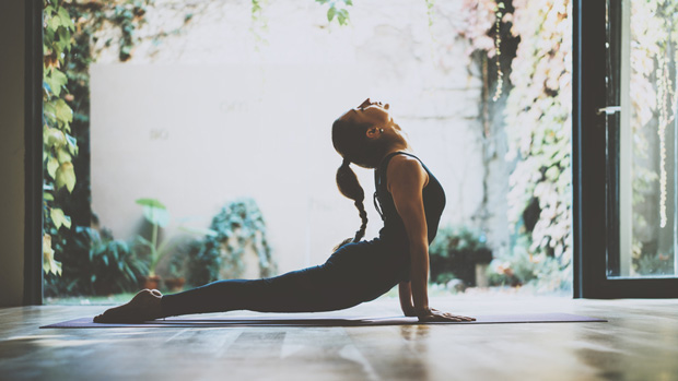 Woman doing yoga in her home.