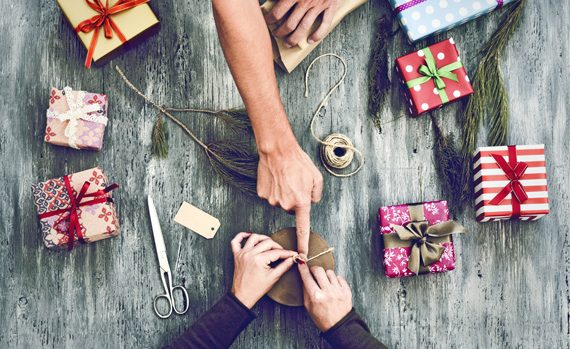 People wrapping holiday gifts