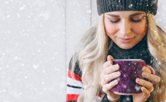 Woman with steaming cup of cocoa