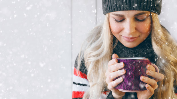 Woman with steaming cup of cocoa