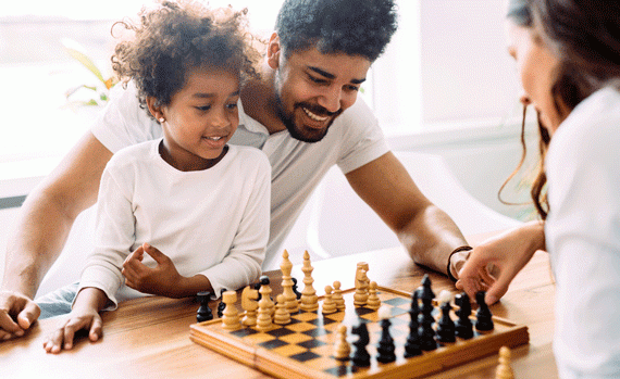 Young family playing chess