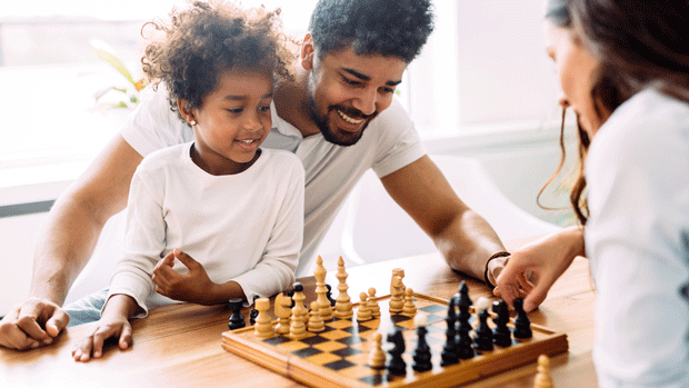 Young family playing chess