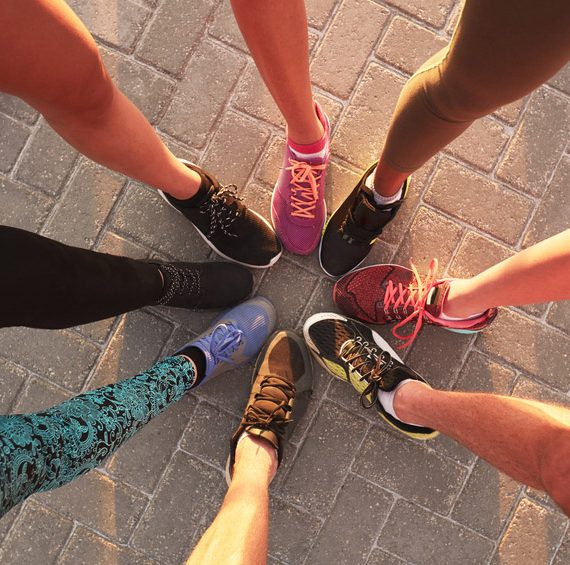 Runners touching sneakers as a group