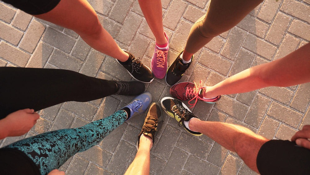 Runners touching sneakers as a group