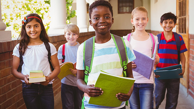 Schoolchildren carrying notebooks at school