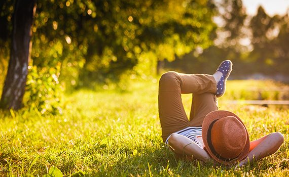 Girl relaxing on grass in the shade