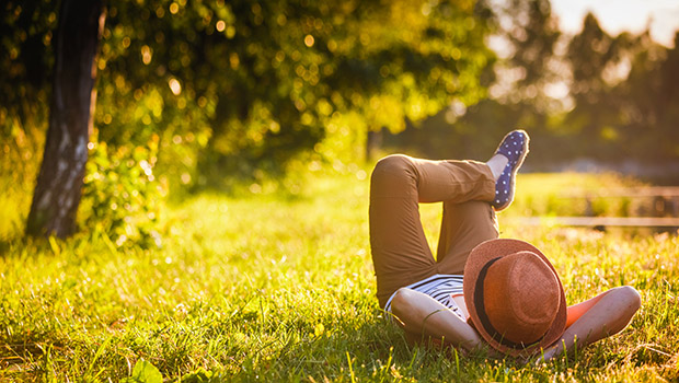 Girl relaxing on grass in the shade