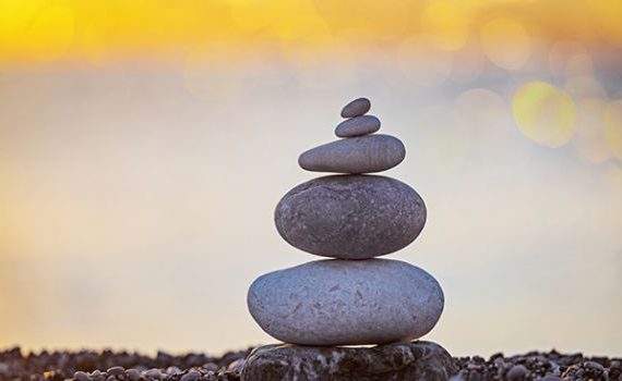 stack of zen stones on pebble beach