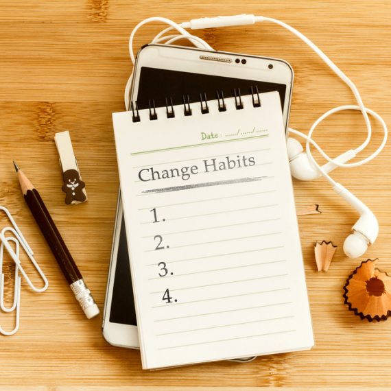 Hand written Change habits message notepad with pencil on wooden table for change habits list for good life concept , overhead shot