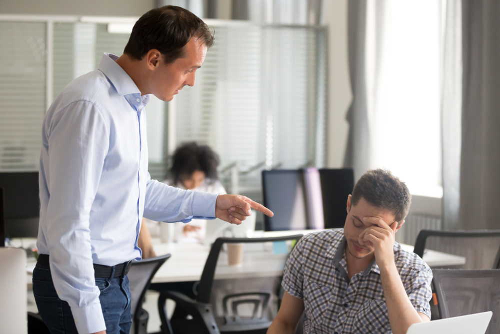 Angry boss ceo scolding rebuking incompetent office worker intern, dissatisfied team leader shouting pointing finger at employee for bad work failure, reprimand or discrimination at work concept