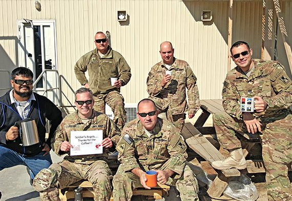 soldiers holding coffee mugs smiling