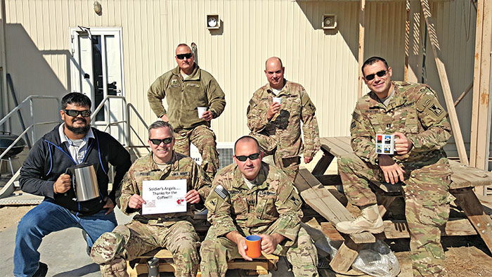 soldiers holding coffee mugs smiling