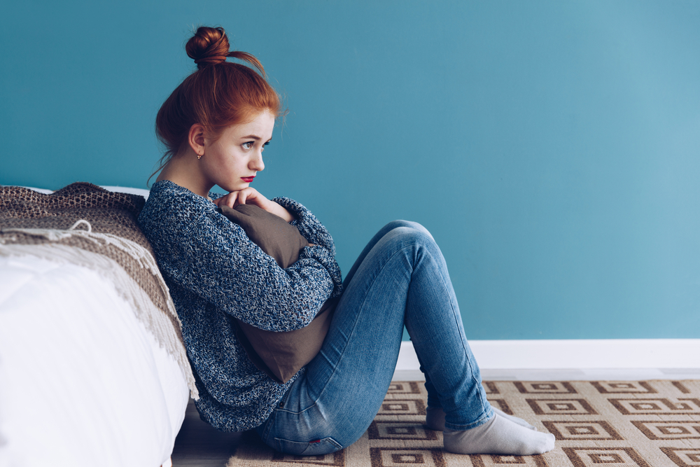 Young alone depressed girl at home