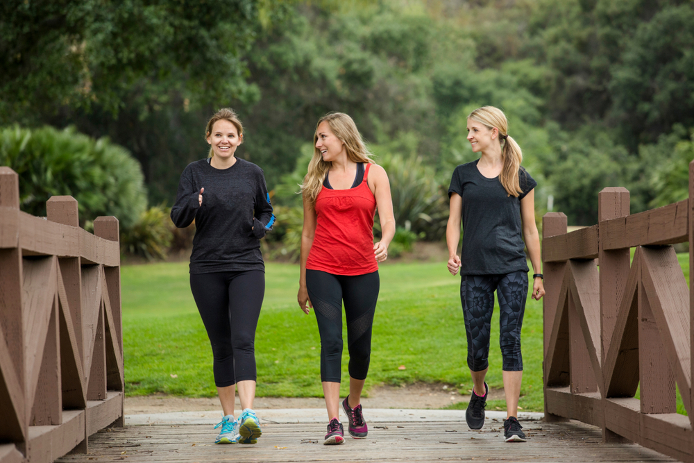 Group of women in their 30s walking together in the outdoors.