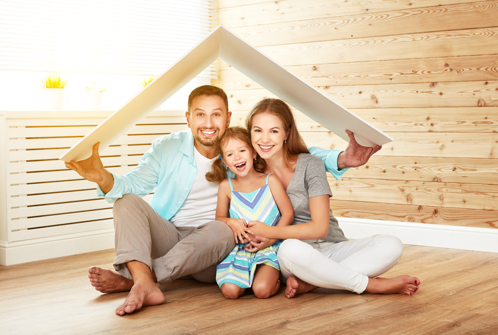 concept housing a young family. Mother father and child in new house with a roof