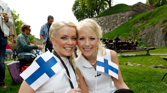 Two happy finish women holding Finland flags