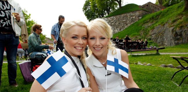 Two happy finish women holding Finland flags